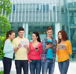 Image showing group of teenagers with smartphones and tablet pc