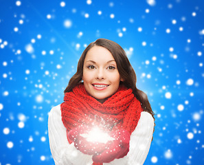 Image showing smiling woman in winter clothes with snowflake