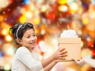 Image showing smiling little girl with gift box