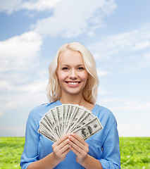 Image showing smiling young woman with us dollar money