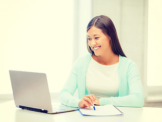 Image showing asian businesswoman with laptop and documents