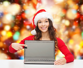 Image showing smiling woman in santa helper hat with laptop