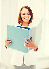 Image showing businesswoman with folders in office