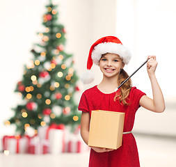 Image showing smiling girl in santa helper hat with gift box