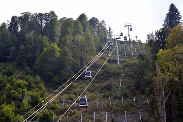 Image showing Closed chair lifts moving along the slope