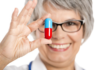 Image showing Female doctor holding  a pill