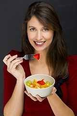 Image showing Woman eating a fruit salad