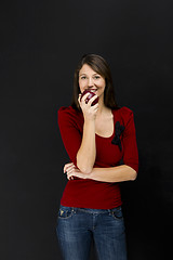 Image showing Young woman eating an apple