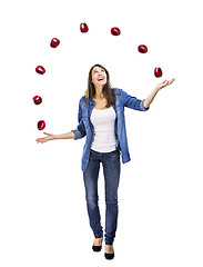 Image showing Woman throwing apples