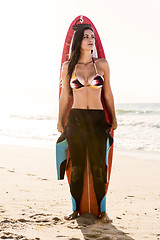 Image showing Surfer girl with her surfboard