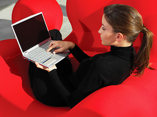 Image showing woman using laptop at home a