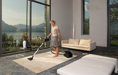 Image showing housewife with vacuum cleaner