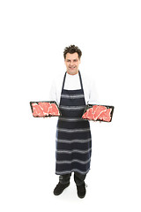 Image showing Butcher with trays of meat