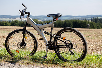 Image showing bike parked in a meadow