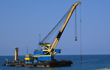 Image showing The floating crane on the seashore