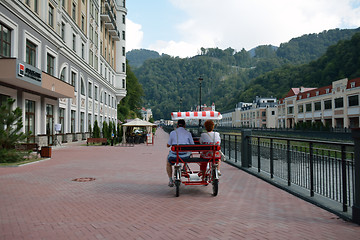 Image showing Two people riding in a car-bike in Krasnaya Polian