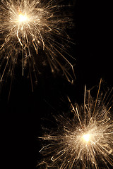 Image showing Burning sparklers on black background