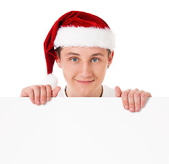 Image showing Young man in Santa hat