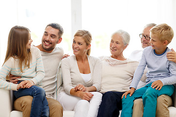 Image showing happy family sitting on couch at home