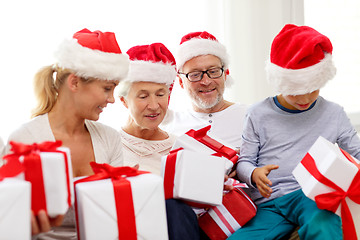 Image showing happy family sitting on couch at home