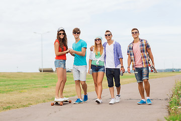 Image showing group of smiling teenagers with skateboards