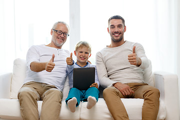 Image showing smiling family with tablet pc at home