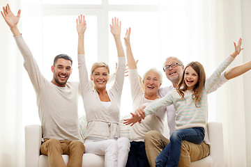 Image showing happy family sitting on sofa at home