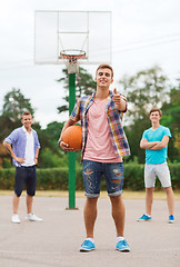 Image showing group of smiling teenagers playing basketball