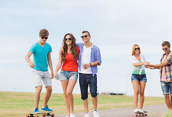 Image showing group of smiling teenagers with skateboards