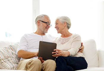 Image showing happy senior couple with tablet pc at home