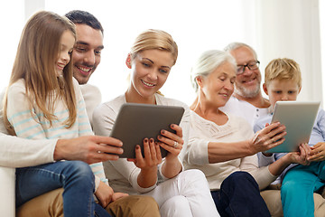 Image showing smiling family with tablet pc at home