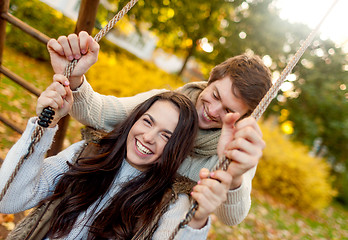 Image showing smiling couple hugging in autumn park