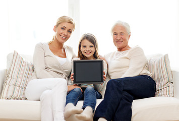 Image showing smiling family with tablet pc at home