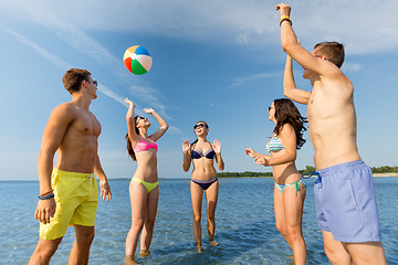 Image showing smiling friends in sunglasses on summer beach