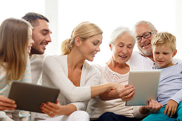 Image showing smiling family with tablet pc at home