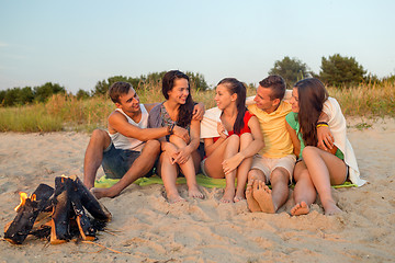 Image showing smiling friends in sunglasses on summer beach