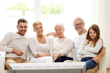 Image showing happy family watching tv at home