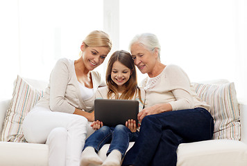 Image showing smiling family with tablet pc at home