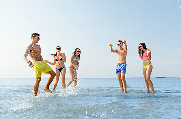 Image showing happy friends having fun on summer beach