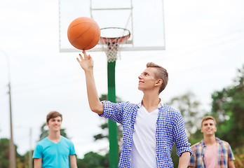 Image showing group of smiling teenagers playing basketball