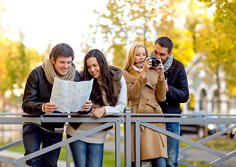 Image showing group of friends with map and camera outdoors