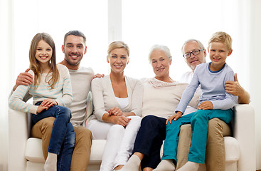 Image showing happy family sitting on couch at home