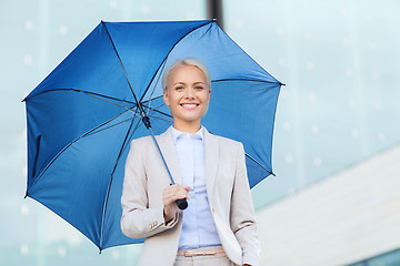 Image showing young smiling businesswoman with umbrella outdoors