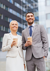 Image showing smiling businessmen with paper cups outdoors