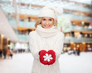 Image showing smiling woman in winter clothes with snowflake