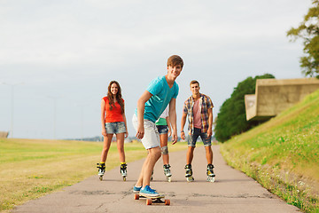 Image showing group of smiling teenagers with roller-skates