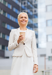 Image showing smiling businesswoman with paper cup outdoors