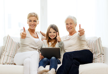 Image showing smiling family with tablet pc at home