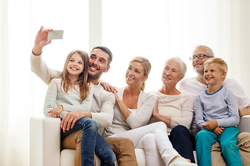 Image showing happy family with smartphone at home