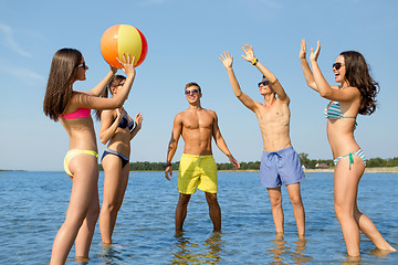 Image showing smiling friends in sunglasses on summer beach